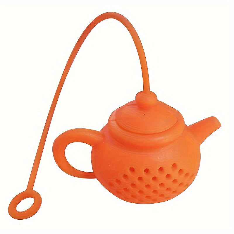 Reusable teapot-shaped tea infuser made of silicone for loose leaf tea, ideal for kitchen and dining use, small in size suitable for making tea.