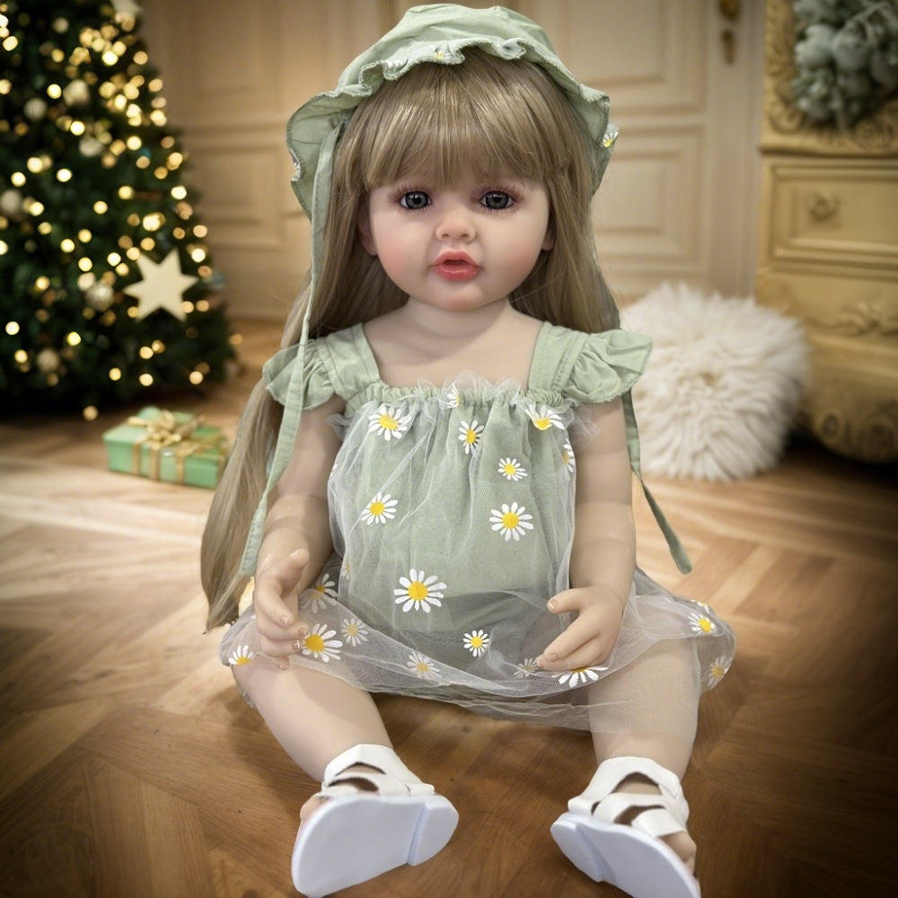 Realistic 55.88 cm full vinyl body reborn baby doll with long blond hair, dressed in a green dress with daisy pattern. Beautiful toddler doll toy for collectors.