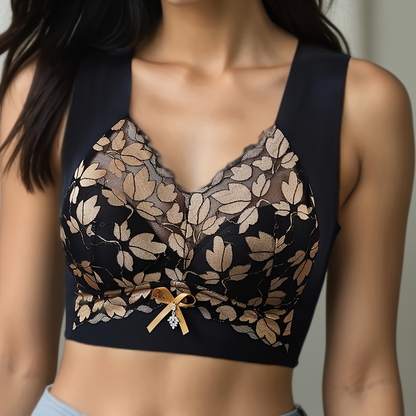 Polyamide and elastane bra with medium support, non-removable padding, plant pattern, contrast lace detail, wireless, scoop neck, and u-back design for spring/summer.