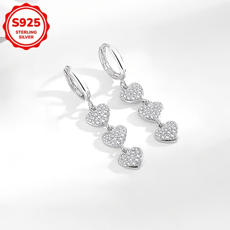 These exquisite ladies' earrings feature dazzling heart-shaped pendants embellished with synthetic zirconia, set in 925 silver. Weighing 3.6g, they are perfect for both daily wear and special occasions such as banquets.