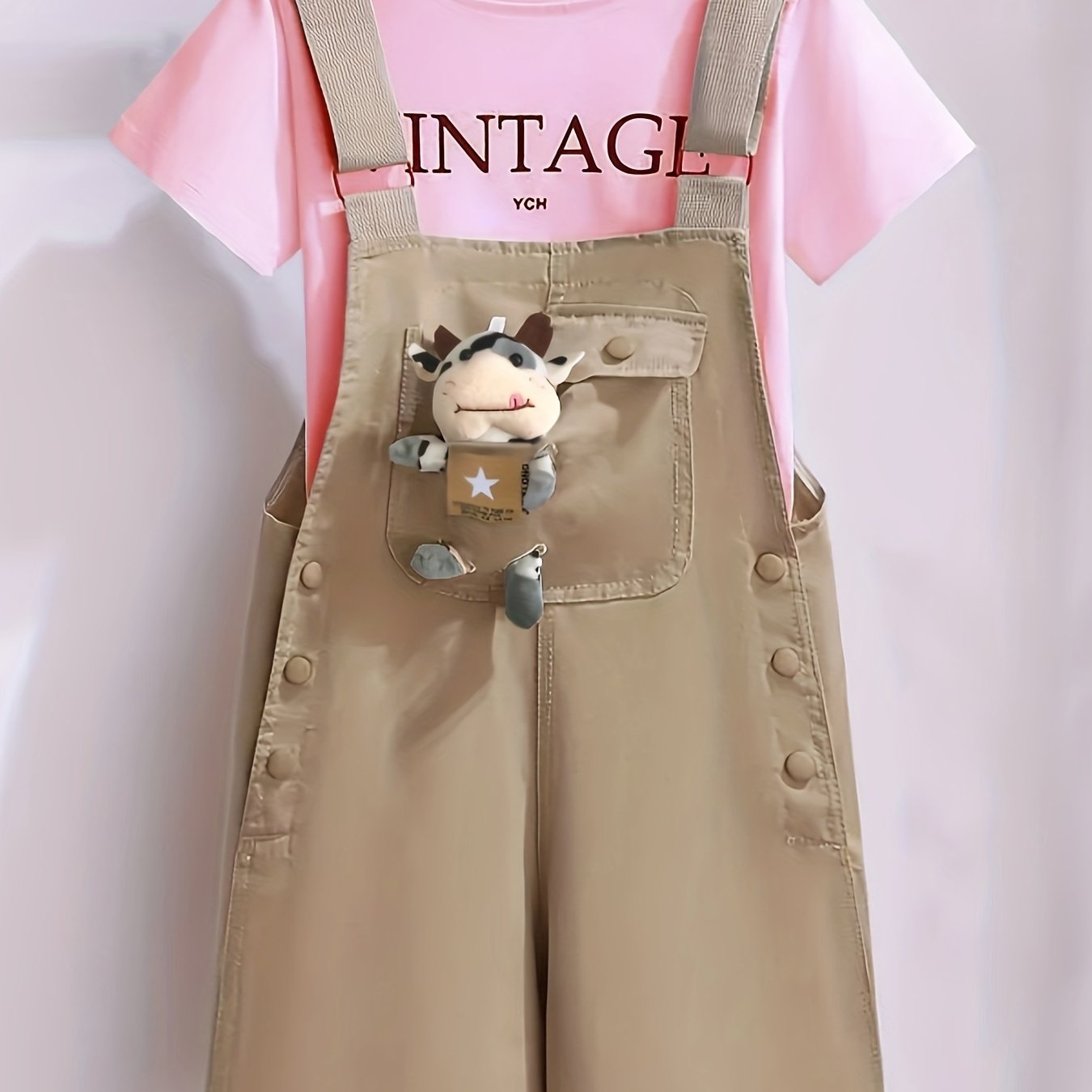 Girls' summer outfit with trendy suspenders and lightweight overalls for outdoor wear.