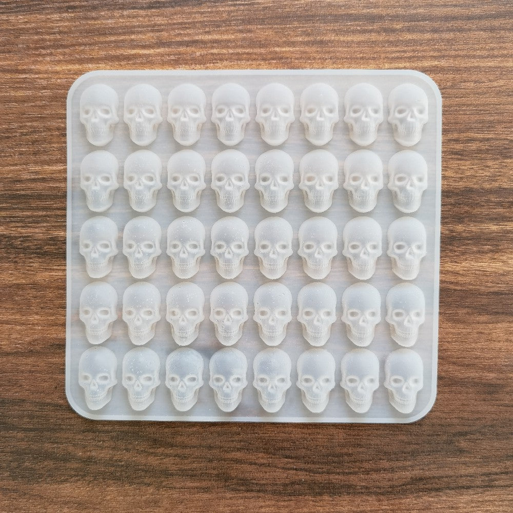 Create spooky ice cubes with this Skull Ice Cube Silicone Mold! Perfect for DIY bar parties and Halloween decor, this mold can also be used to make cool whiskey, wine, chocolate, soap, cake, fondant, and more. The mold features 40 holes, providing you