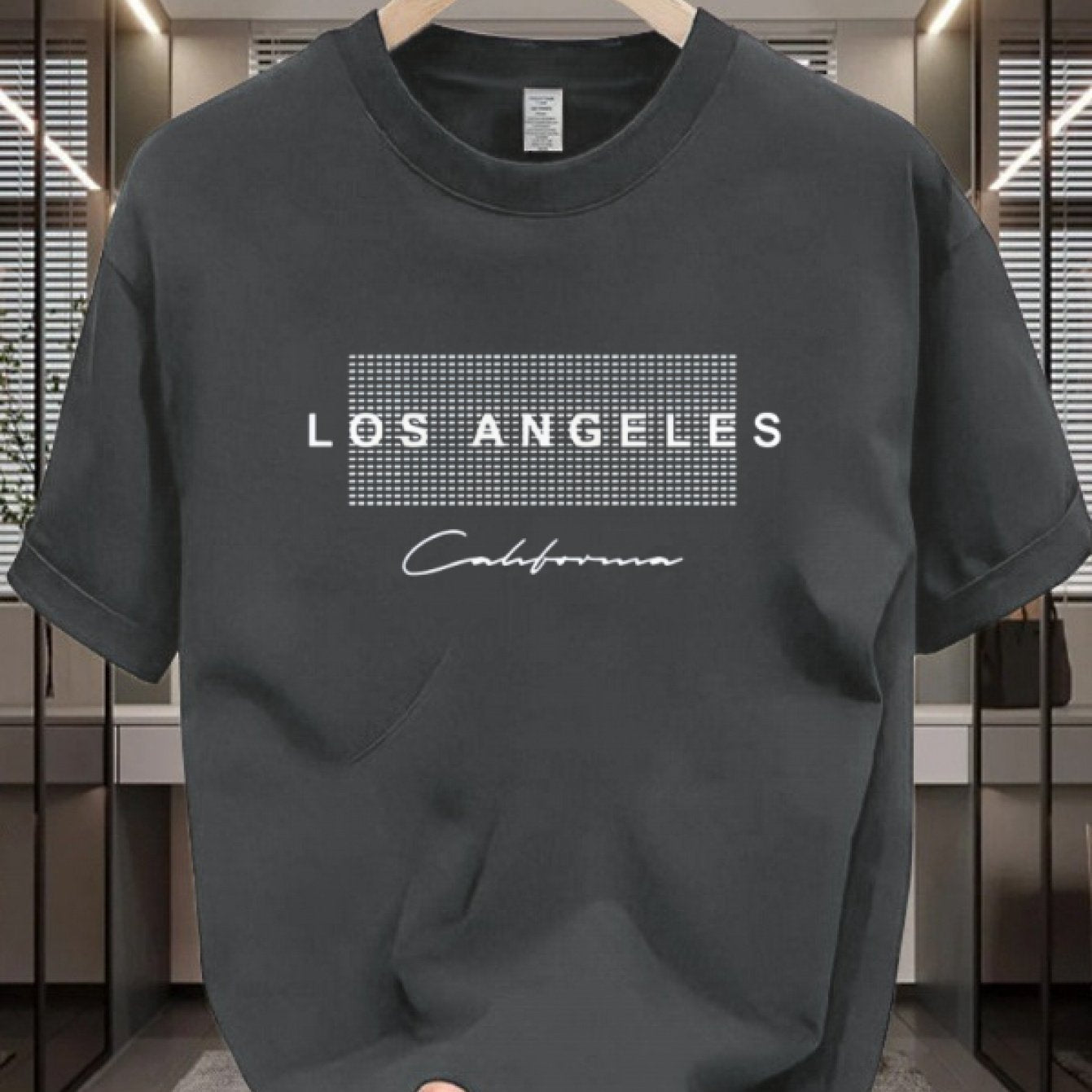 Men's casual cotton T-shirt with crew neck and short sleeves. Made from 100% cotton knit fabric, providing all-season comfort. Features a solid color and a Los Angeles California graphic