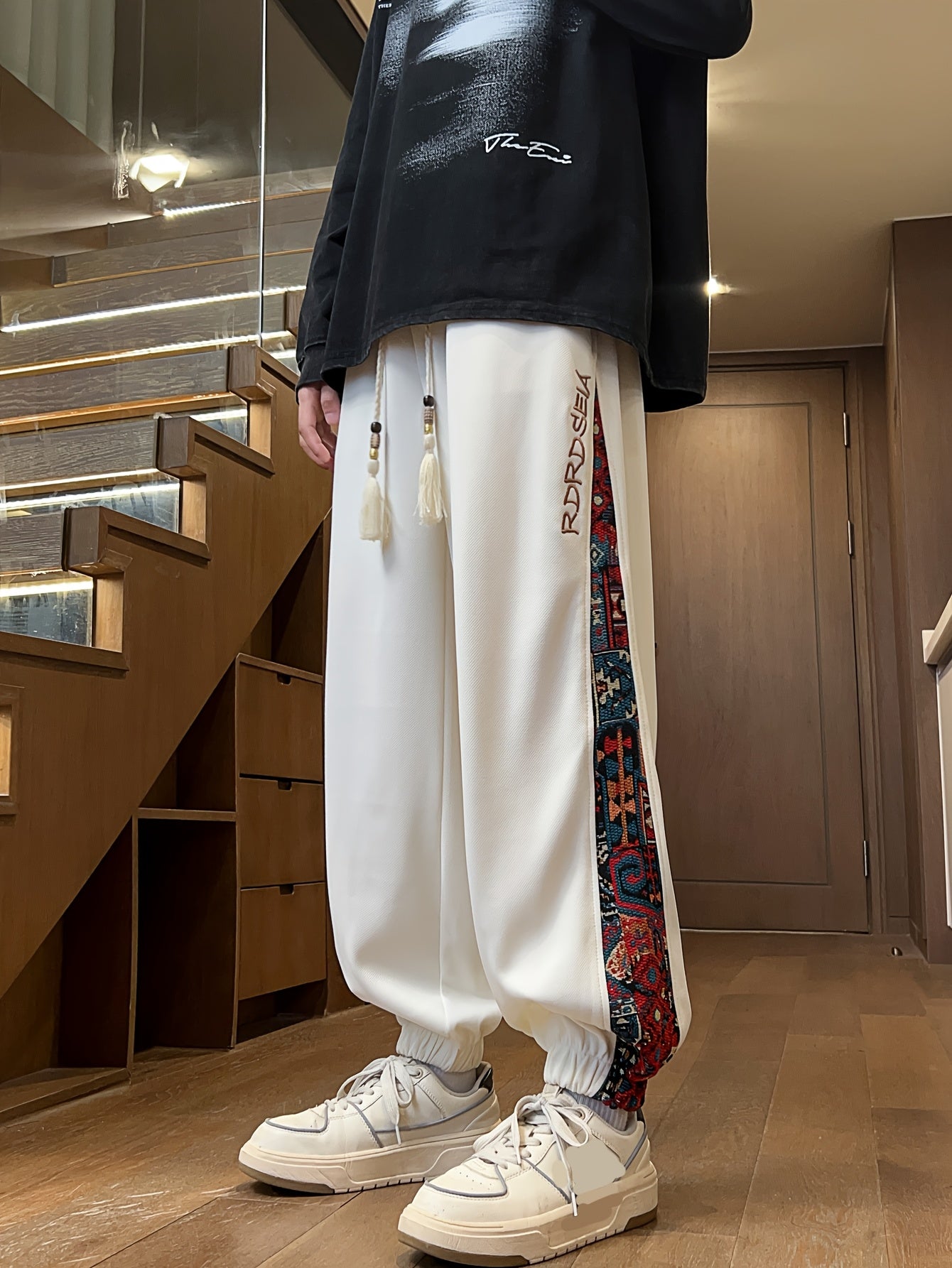 Men's stylish long pants with ethnic style patchwork and letter embroidery, casual jogger sports trousers.