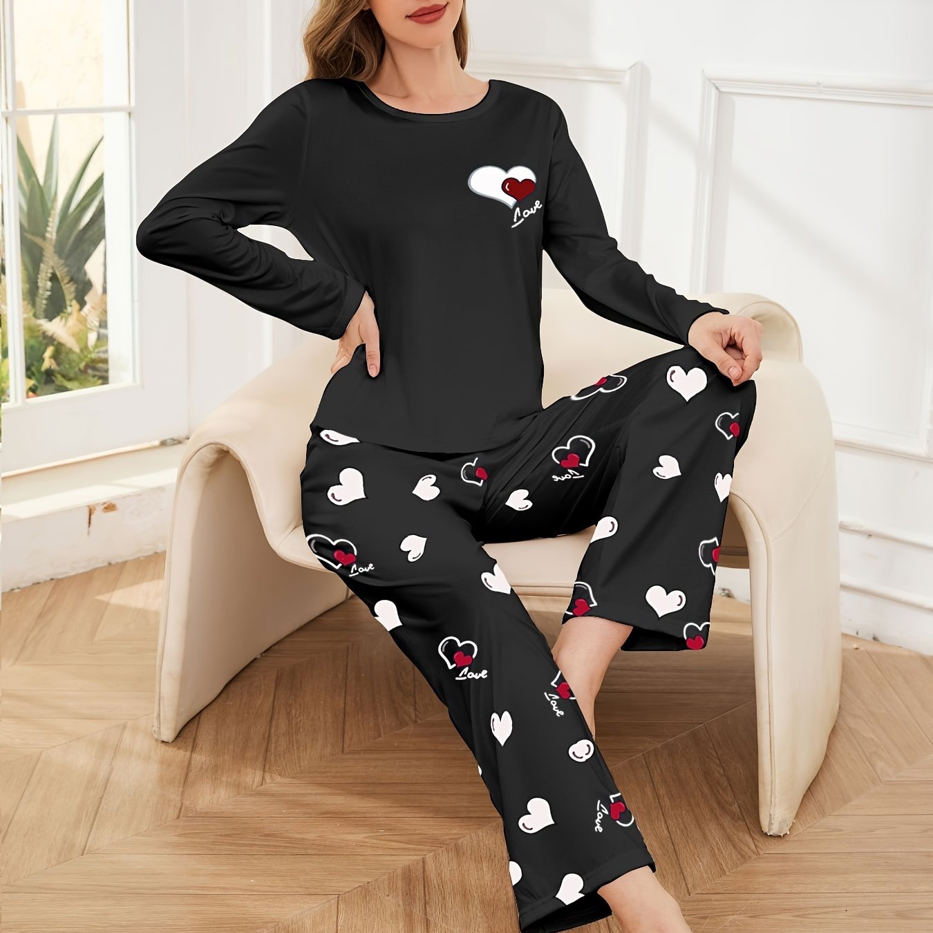 Women's heart print 2-piece pajama set includes long sleeve crew neck top and elastic waist pants in cozy polyester blend for fall/winter.