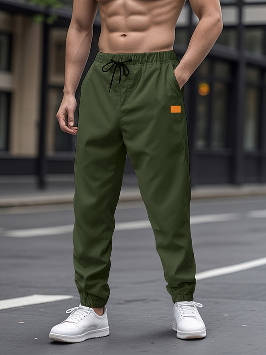 Durable woven fabric casual drawstring pants for men with solid color and regular fit.