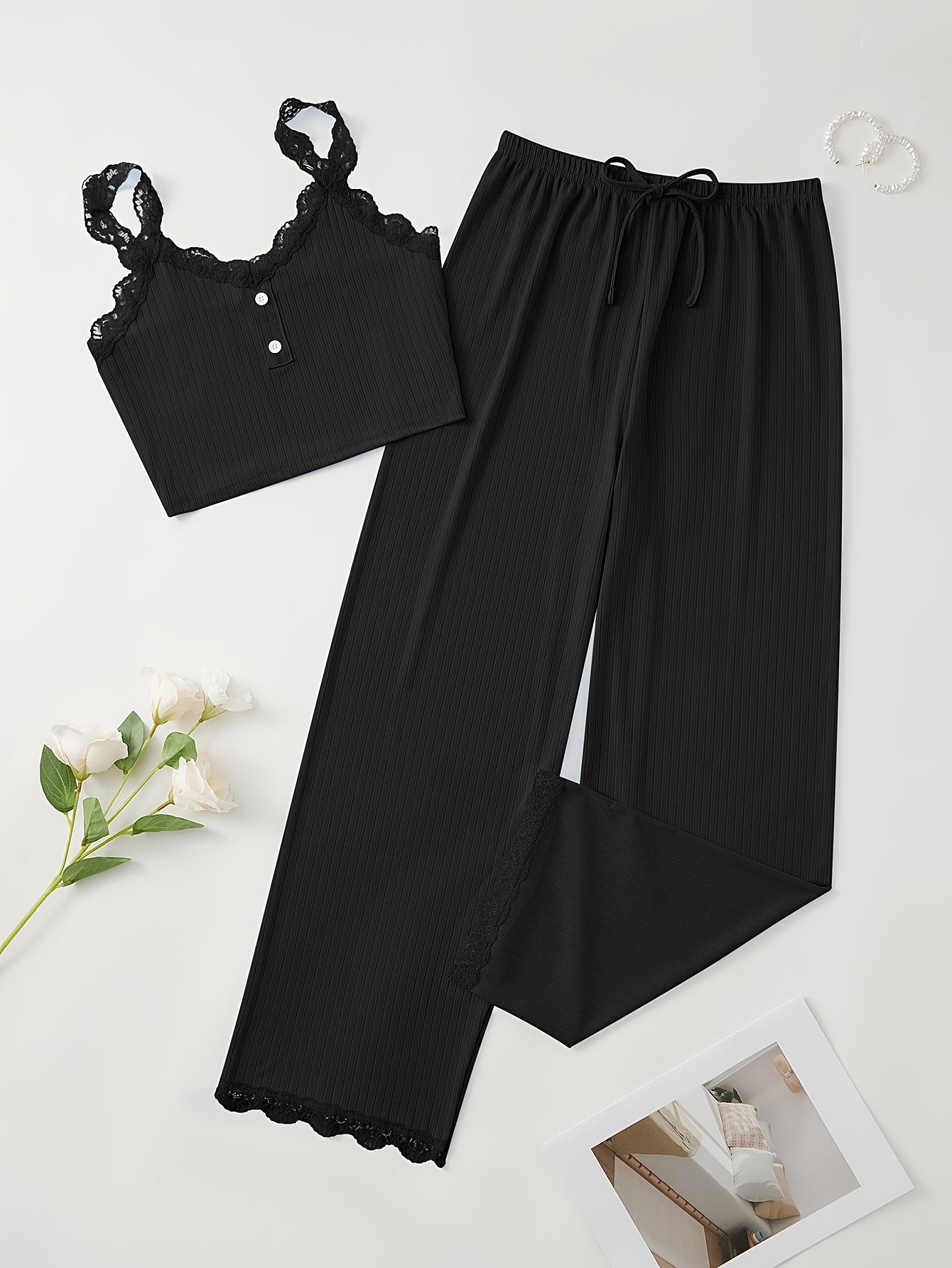 Women's loungewear set with lace trim, crew neck cami top, and lace-up pants.