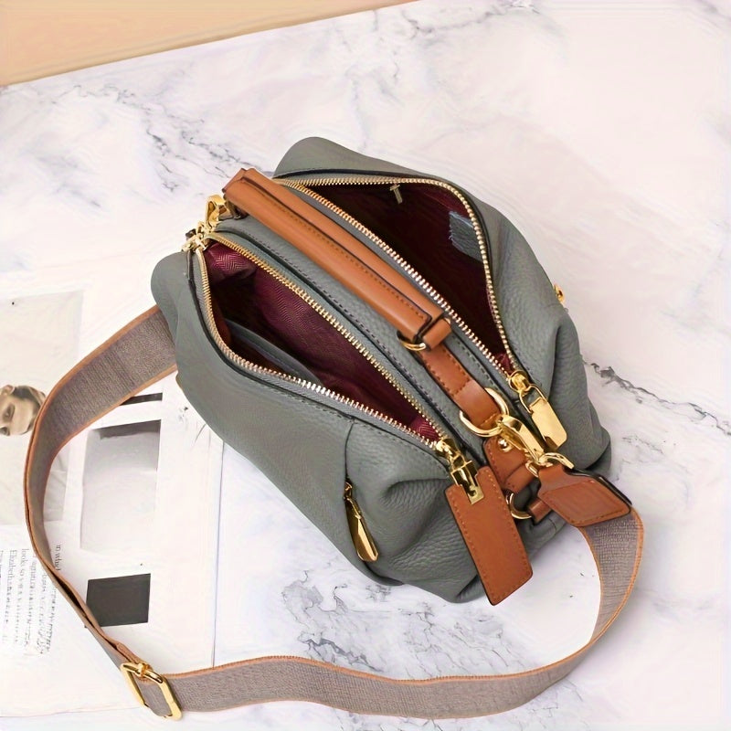 Genuine leather fashion handbag for women with versatile carrying options, large capacity, and stylish design.