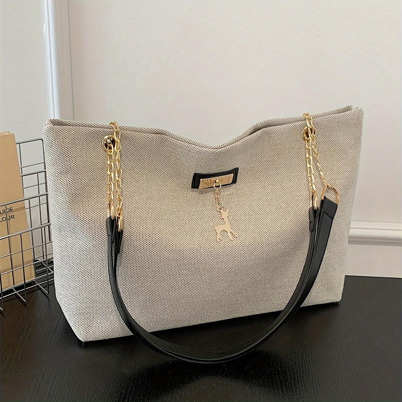 Polyester tote bag for women with deer charm, adjustable strap, zipper closure, painted edges, and messenger bag style.