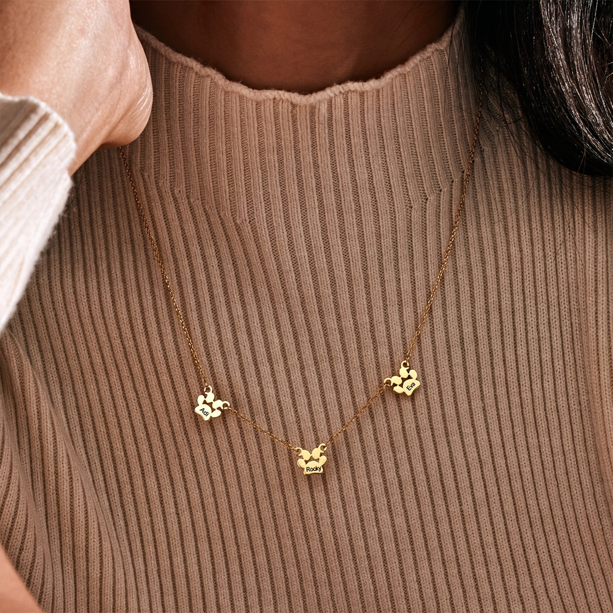 Get your hands on this exquisitely crafted 18K gold-plated copper pet paw necklace, featuring custom engraving of your pet's name and claws design. The cute and simple script and numeric symbols make it a stylish accessory perfect for everyday wear or