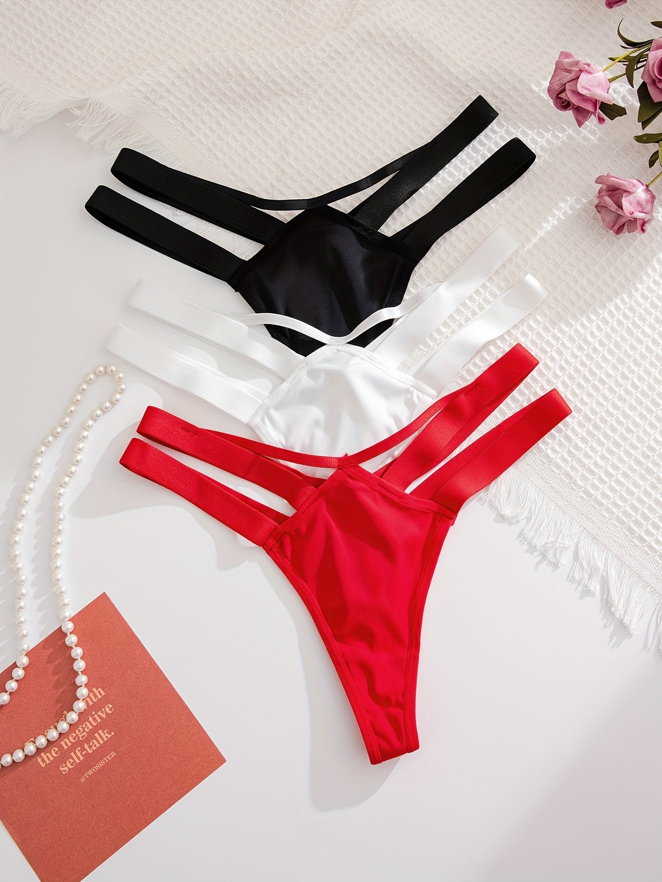 3 elegant women's thongs in black, white, & red made of soft nylon & elastane blend. Non-see-through, hand washable, comfortable, and stylish with adjustable straps.