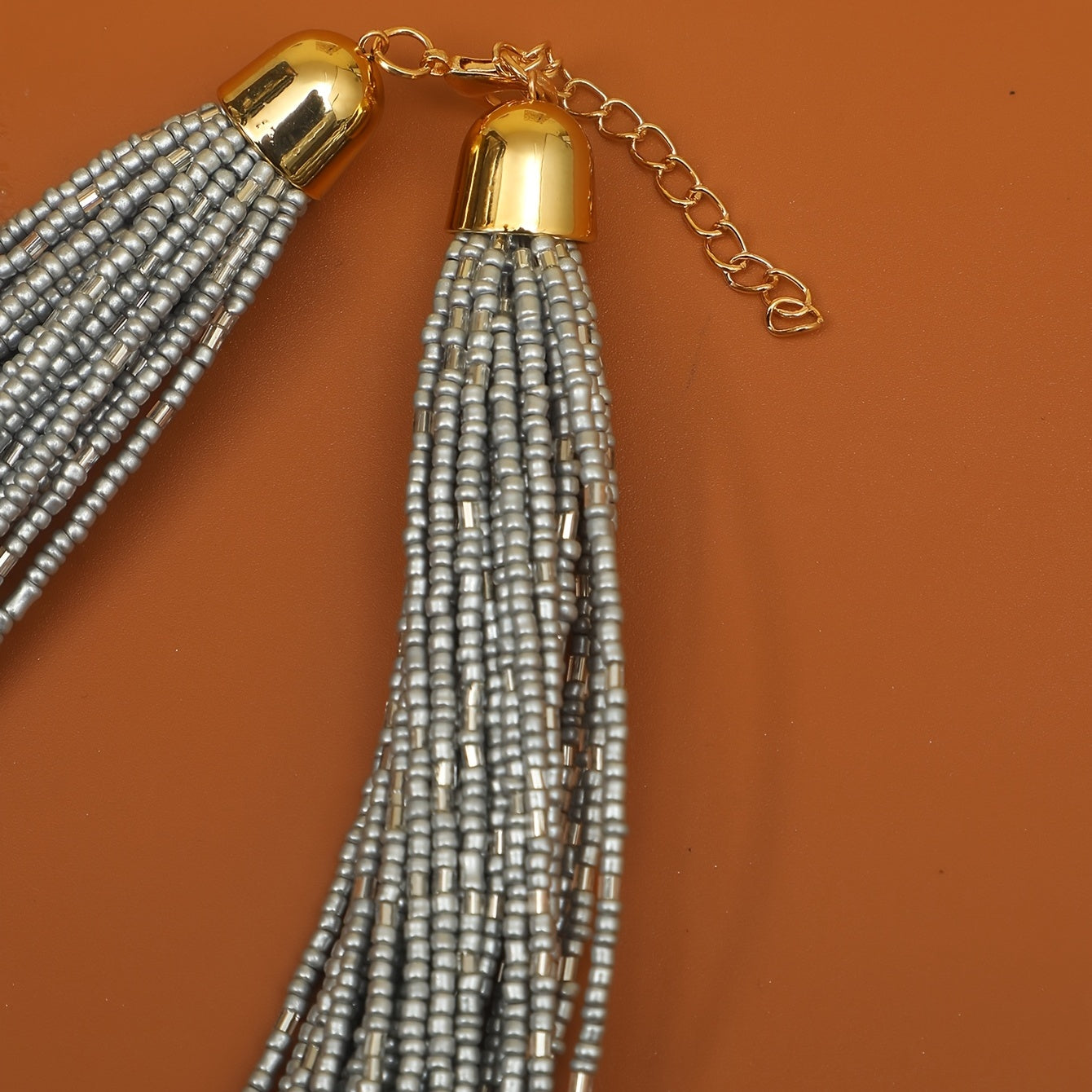 A trendy and flexible millet bead necklace with multiple layers.