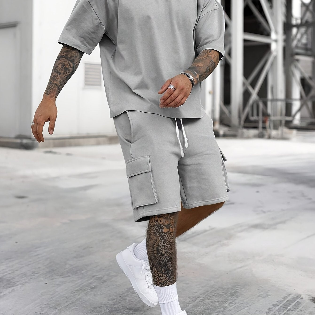 Men's casual sportswear set includes polyester t-shirt and drawstring shorts with pockets, ideal for summer and machine washable.