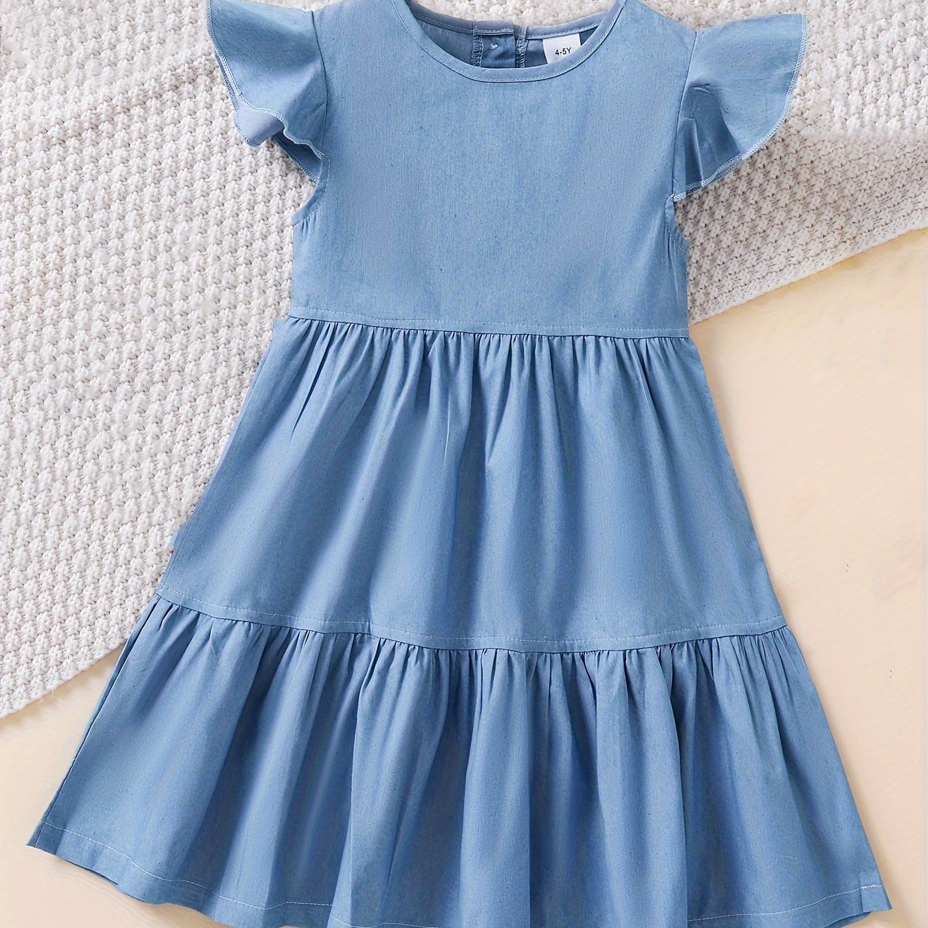 Stylish denim dress for girls with ruffle trim, made of cotton blend and machine washable, ideal for summer