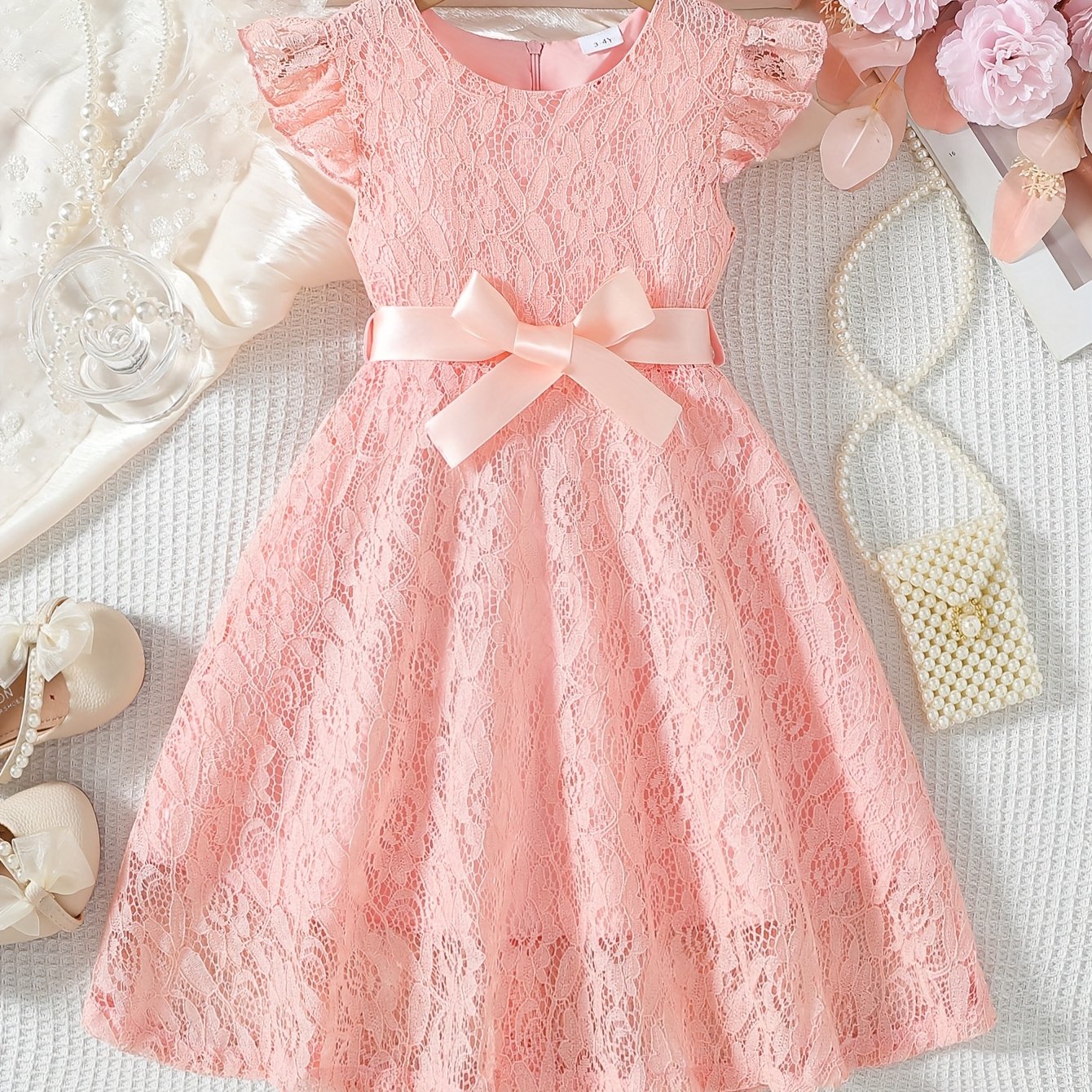 Girls' spring/summer dress with lace detail, belt, and flutter sleeves, ideal for daily wear or birthday parties.