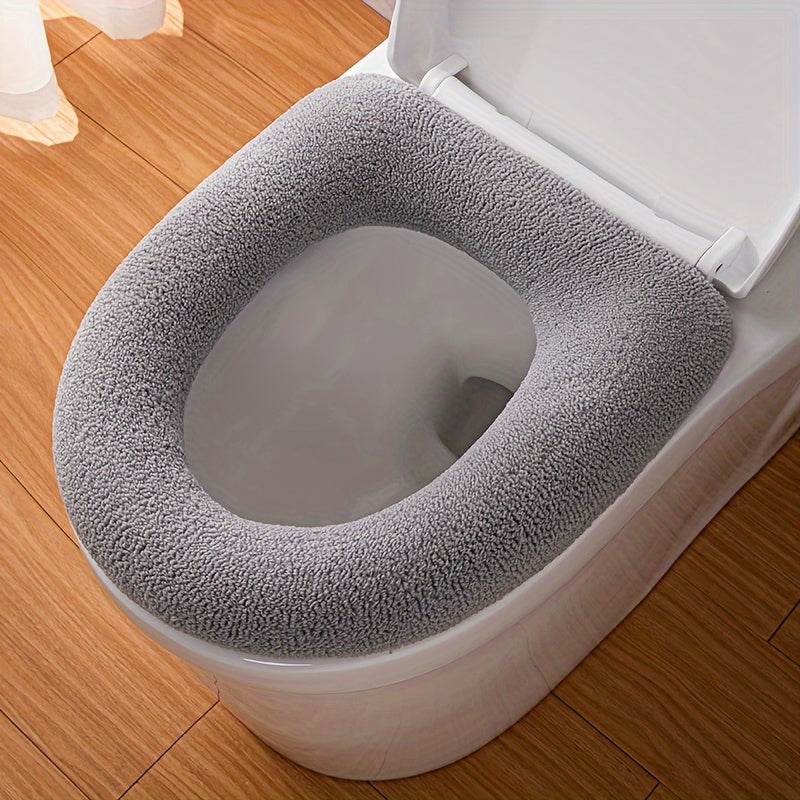 Thickened toilet seat cover with handle in cute cartoon solid colors, soft and comfortable.