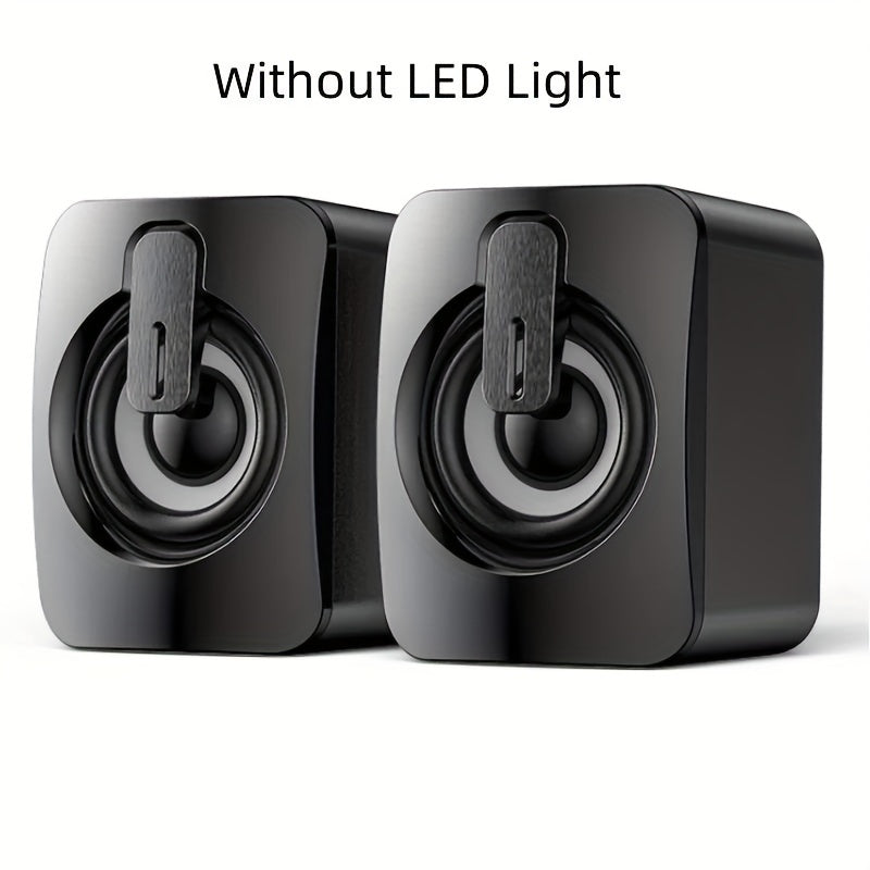 Desktop computer speakers with LED lights and microphone are wired.