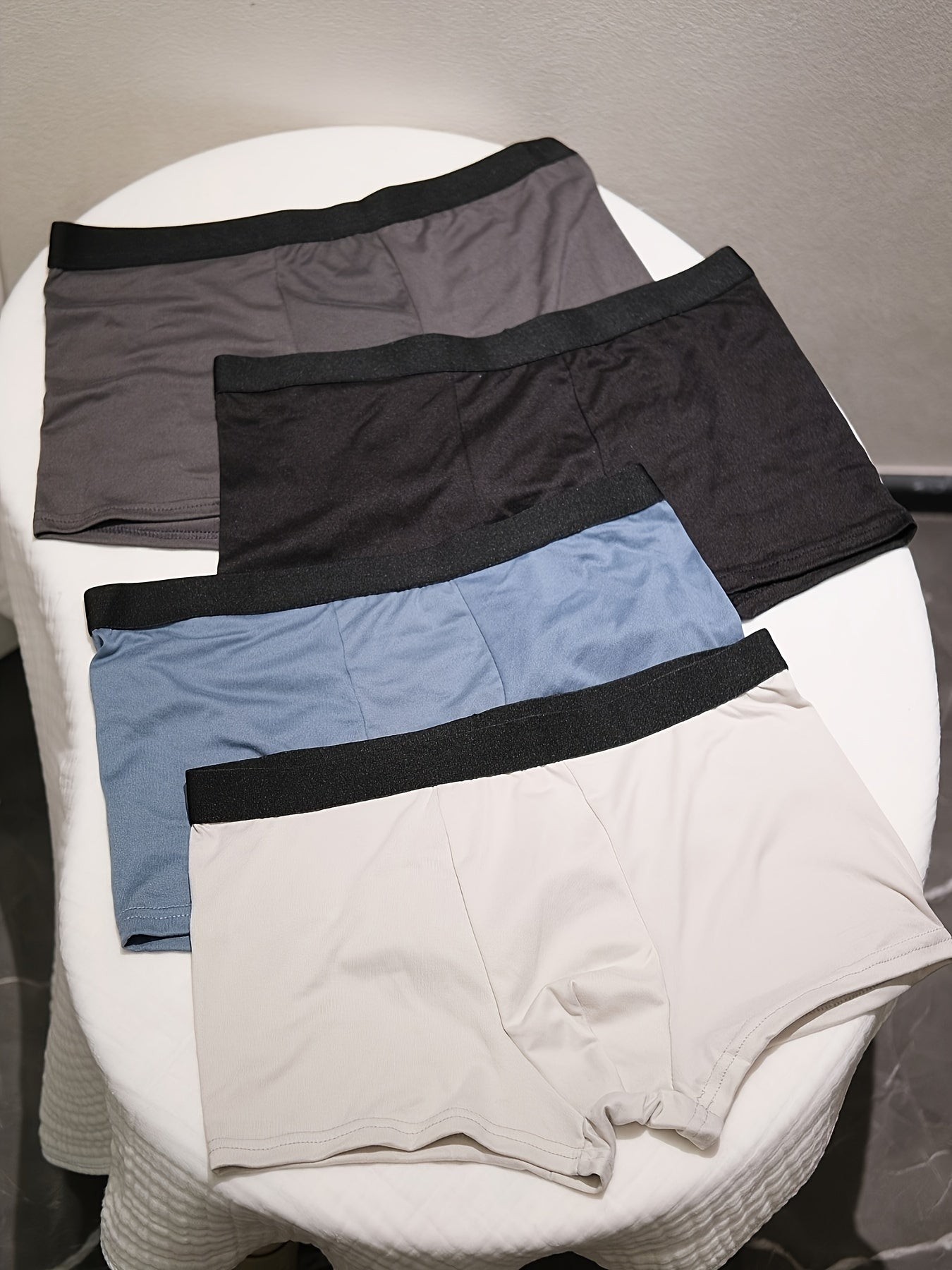 4-pack of men's breathable boxer briefs made from a comfortable, stretchy polyester-spandex blend. Solid color shorts with elastic waistband that are non-see-through and made from