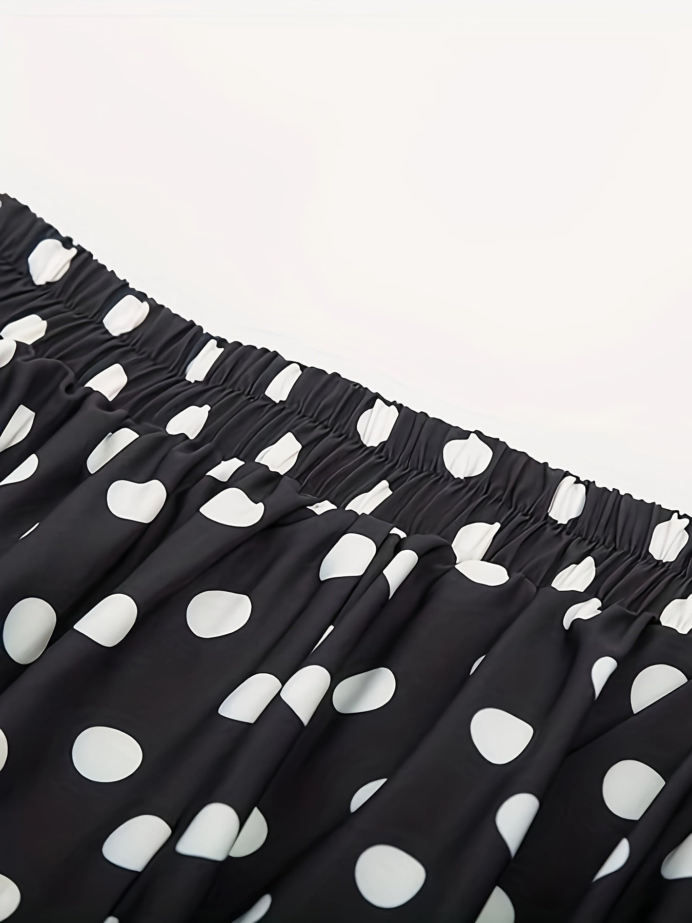 High waist flared skirt with polka dots and ruffled hem.