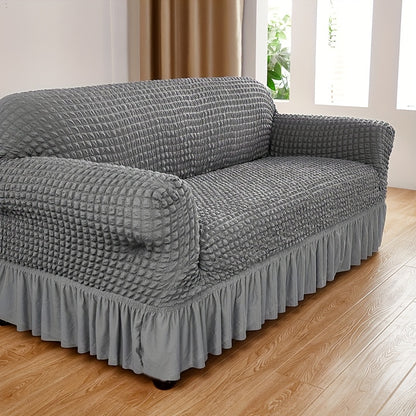 Seersucker skirt sofa cover protects couch from cat scratches in bedroom, office, or living room.