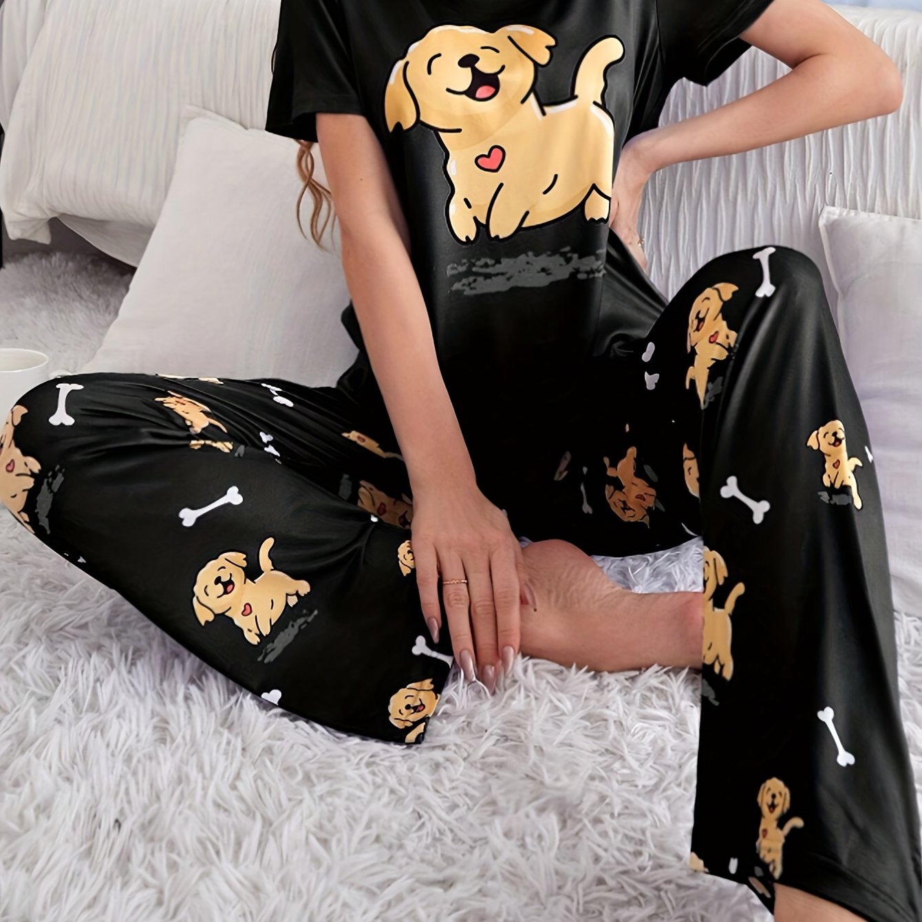 Women's sleepwear set with cute puppy print, short sleeve top, and elastic pants.