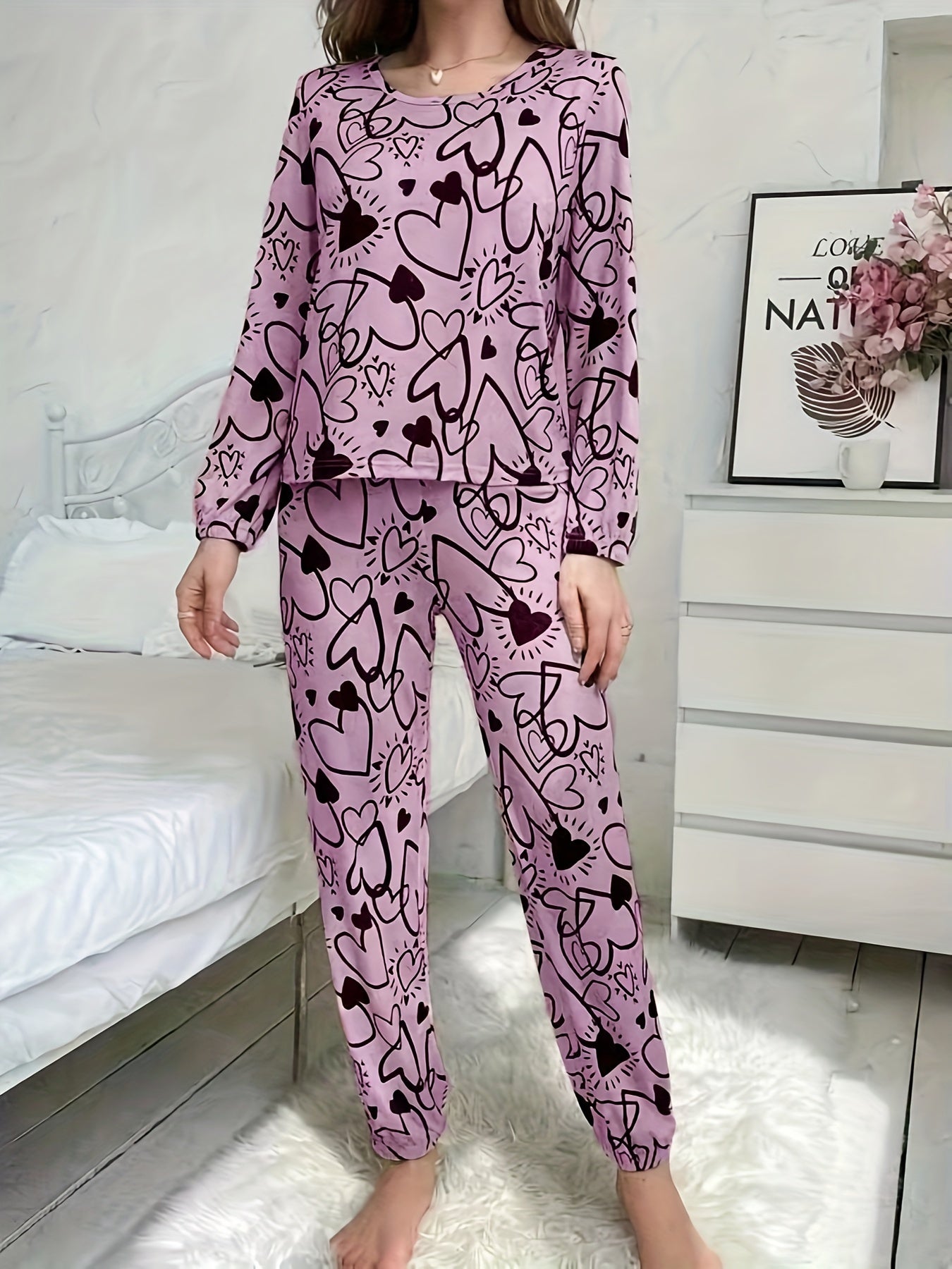 Women's lounge set with heart print, long sleeve top, crew neck, and elastic waistband pants for loungewear and sleepwear.