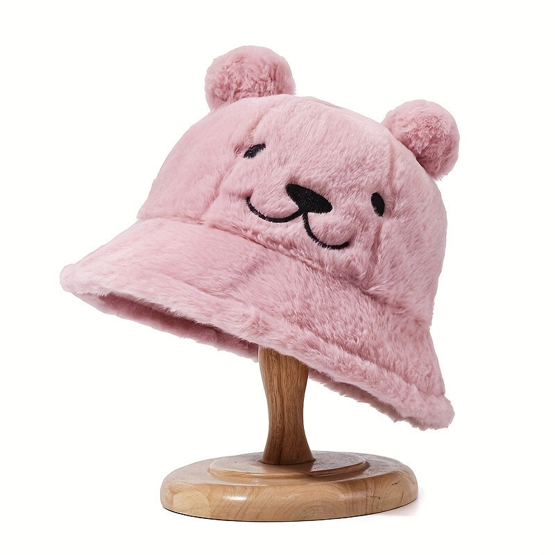 Women's fuzzy bucket hat with cute bear embroidery in yellow and white. Hand washable for cozy winter wear.