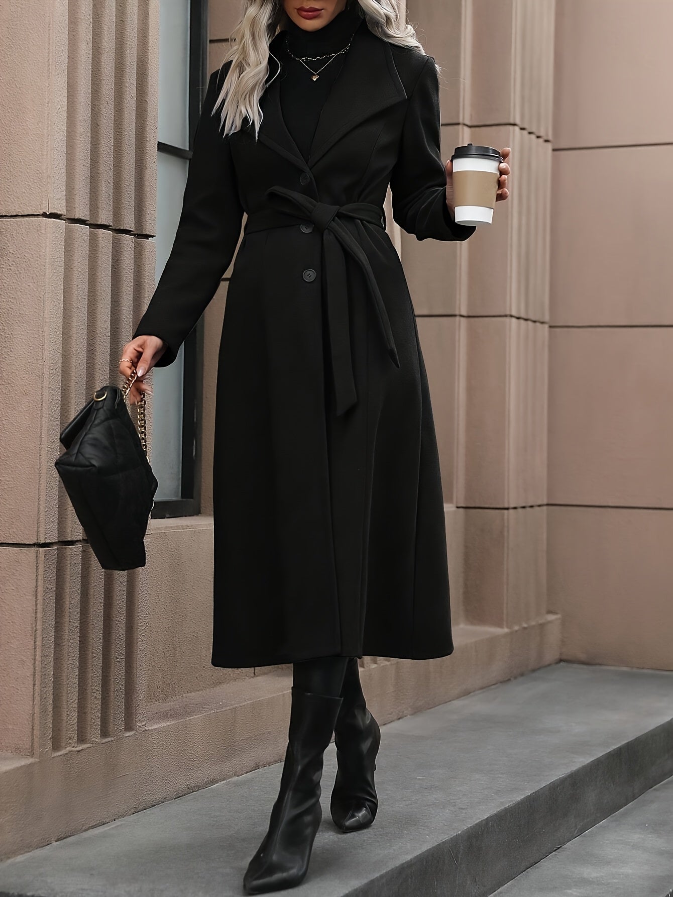 Stylish black trench coat with belt for women's fall/winter outerwear collection.