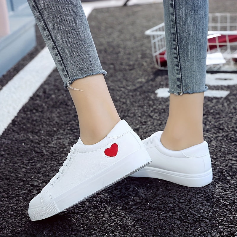 Stylish women's casual sneakers with heart-shaped design, lace-up style, and flat white soles - ideal for leisure wear.