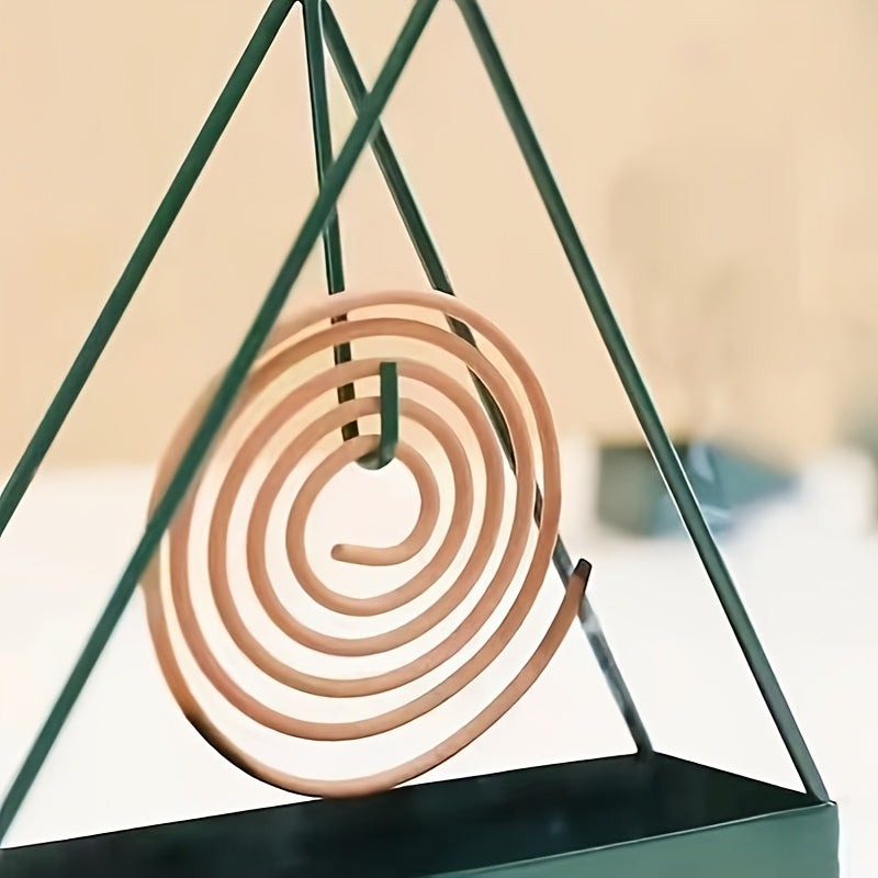 Sleek black metal mosquito coil holder with triangular design incense burner and wooden spiral insert. Ideal for home decor and indoor air freshening. Unsceted and made of metal for a modern touch.