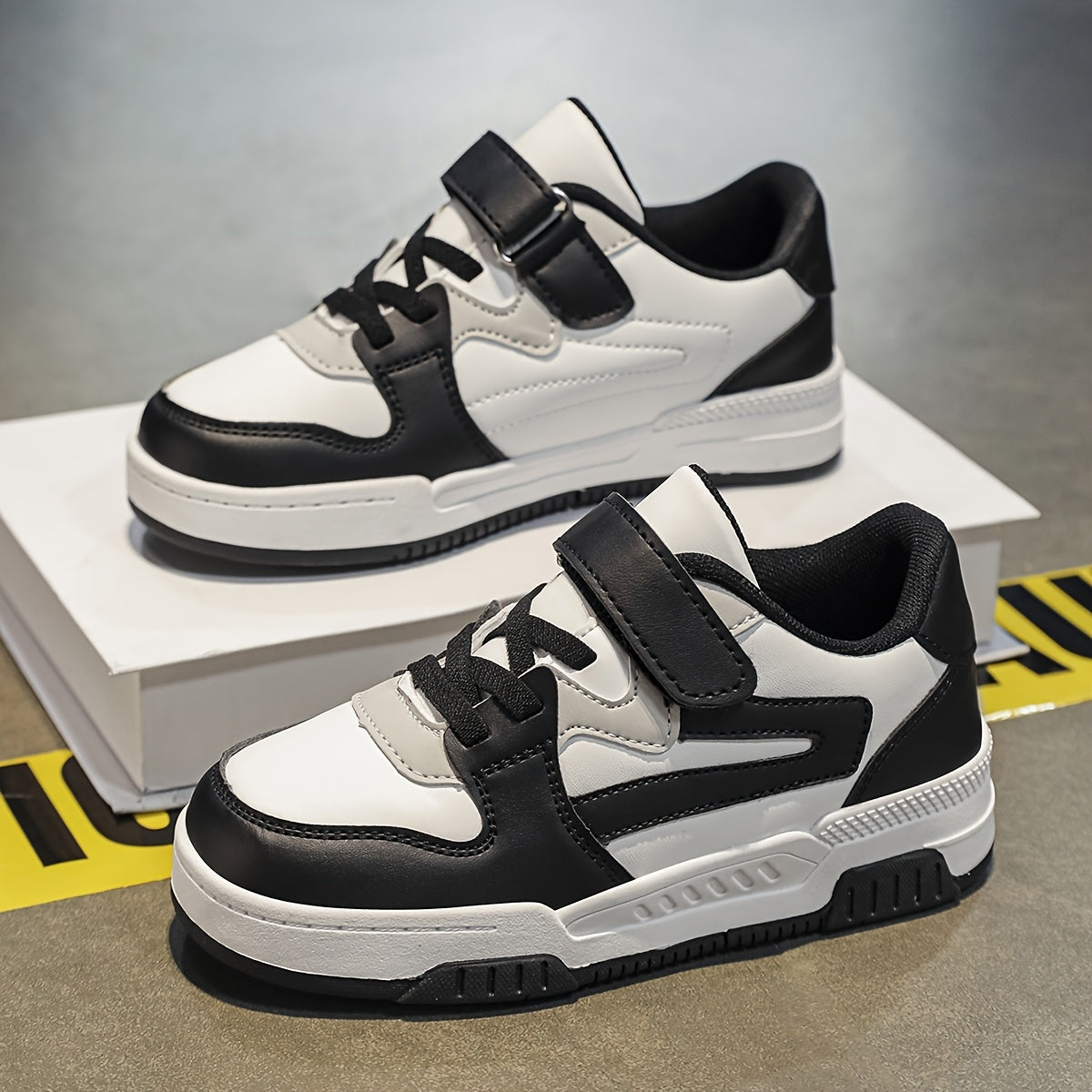 Boys' athletic sneakers in black, white, and grey with non-slip, breathable lining, hook-and-loop strap, and durable sole. Perfect for all seasons.