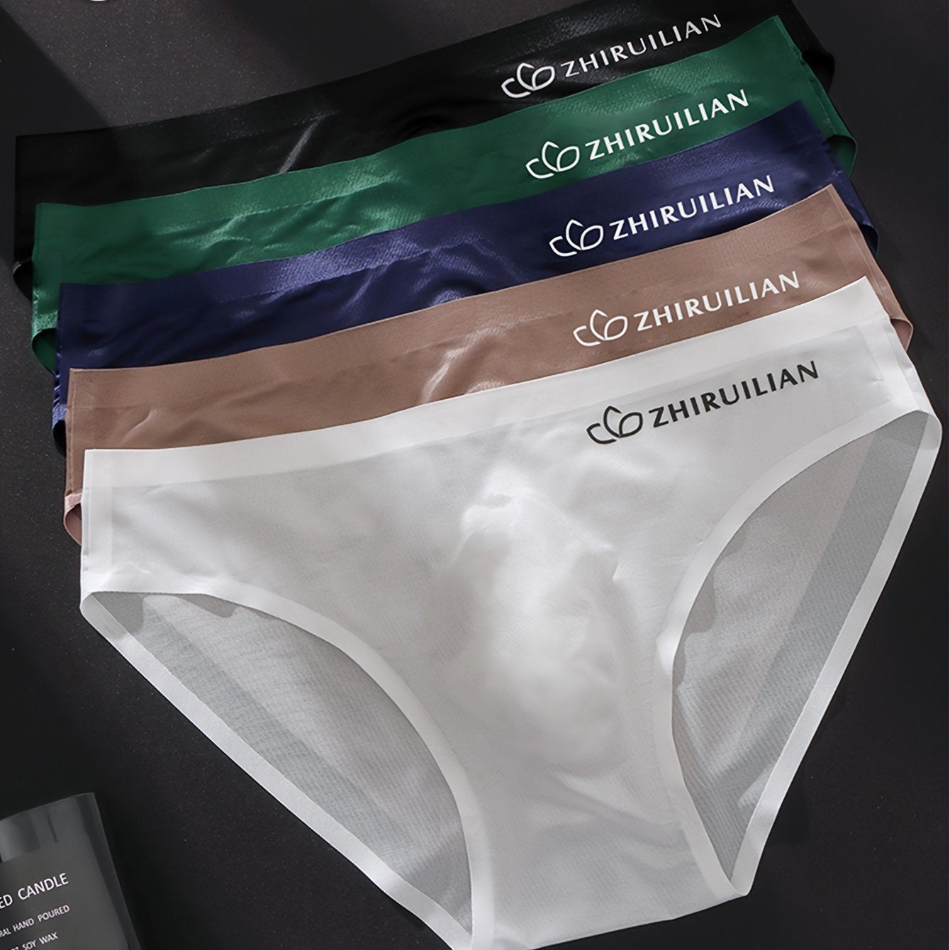 5-pack of men's seamless boxer briefs made of 68% nylon and 32% spandex knit fabric. Lightweight, stretchy, and comfortable with a solid color and letter print design. 150gsm.