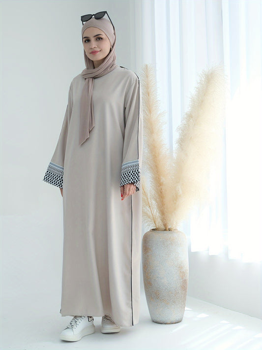 Stylish embroidered zippered abaya dress with long sleeves for Middle Eastern Muslim fashion. Made from polyester knit fabric, part of the spring/fall collection. Features a regular fit and