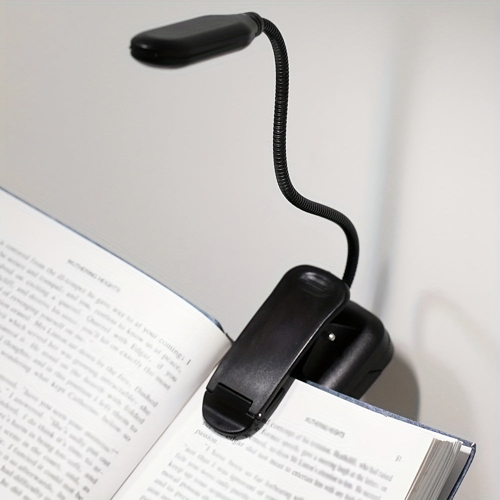 Portable battery-powered clip-on book light for reading that can also be used as a small table lamp or night light for room decor.