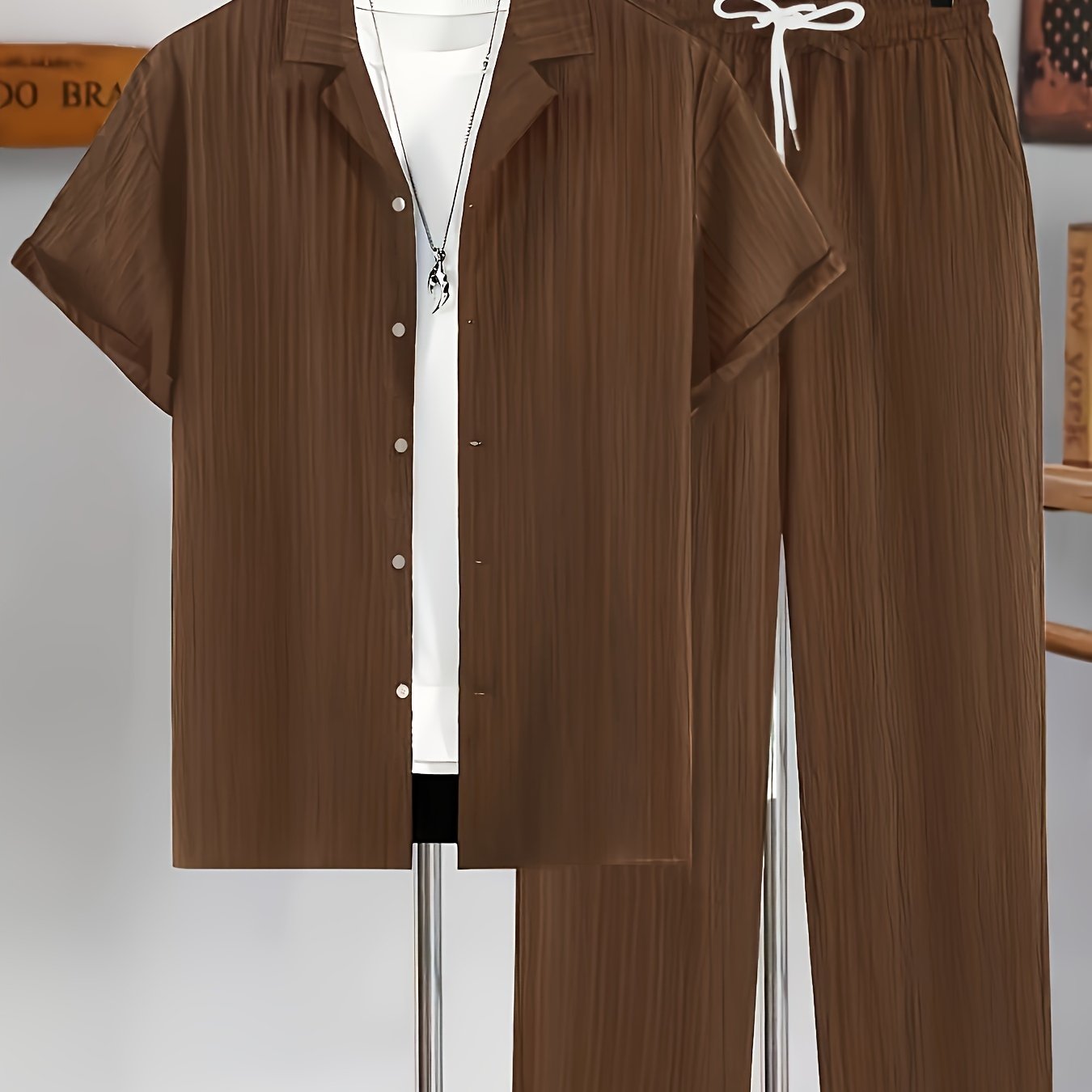 Men's casual two-piece set for summer leisure: short sleeve button-up shirt and drawstring pants.