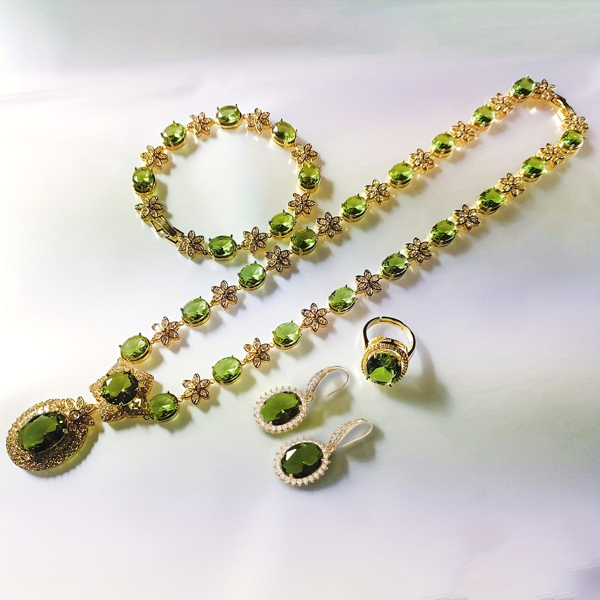 Introducing the MEETMAY Synthetic Color Changing Sultanite Diaspore Oval Sunflower Jewelry Set. This elegant copper-tone four-piece set includes a ring, earrings, bracelet, and necklace. The colors are customizable to adapt to different lighting