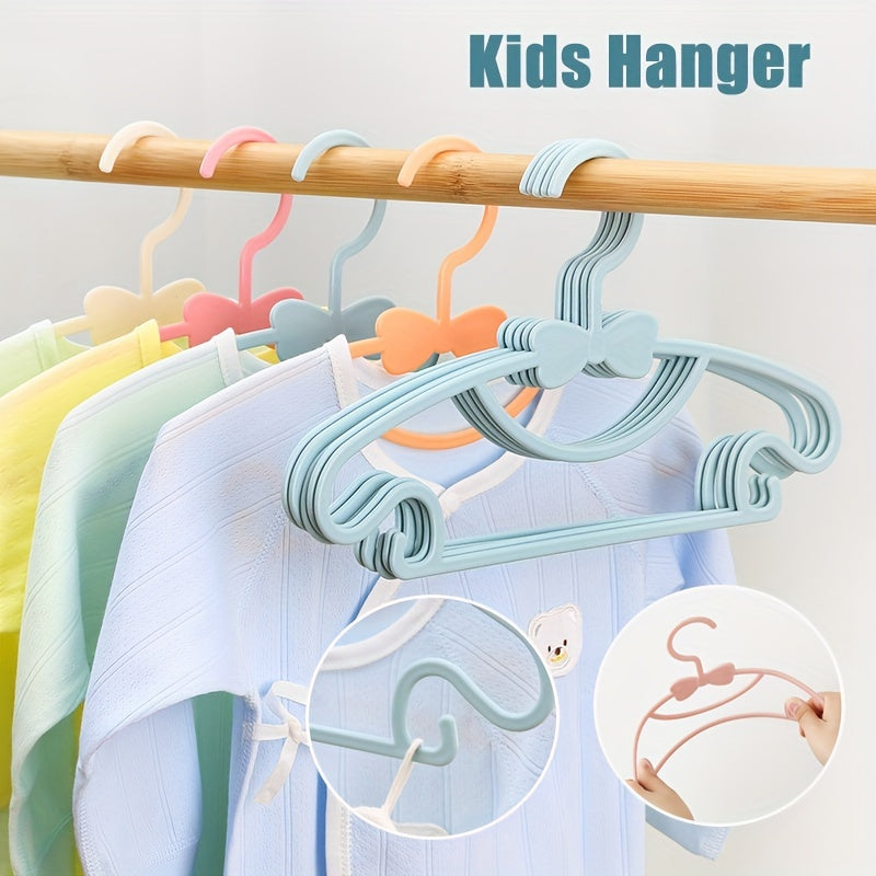 Set of 10 Kids Clothes Hangers made of PP Material, perfect for hanging Newborn and Children's Clothing. Features a cute Bow design, ideal for organizing Wardrobe storage. These strong and durable hangers come with hooks and are suitable for children