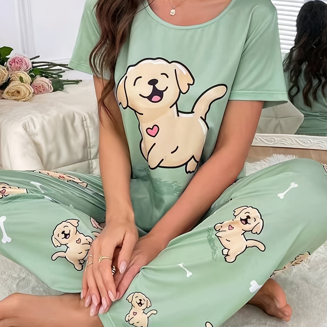 Women's sleepwear set with cute puppy print, short sleeve top, and elastic pants.