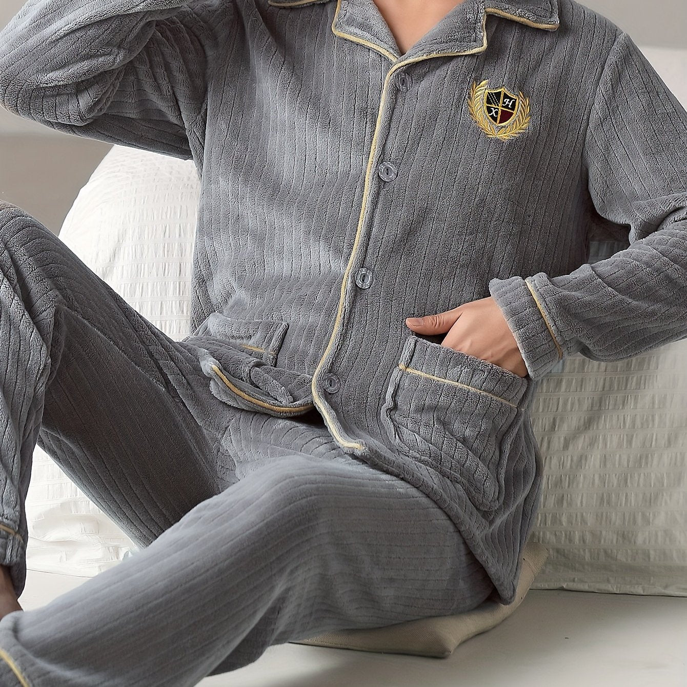 Men's cozy flannel pajama set with lapel collar top and solid color loose fit pants made from 100% polyester knit fabric for fall/winter.