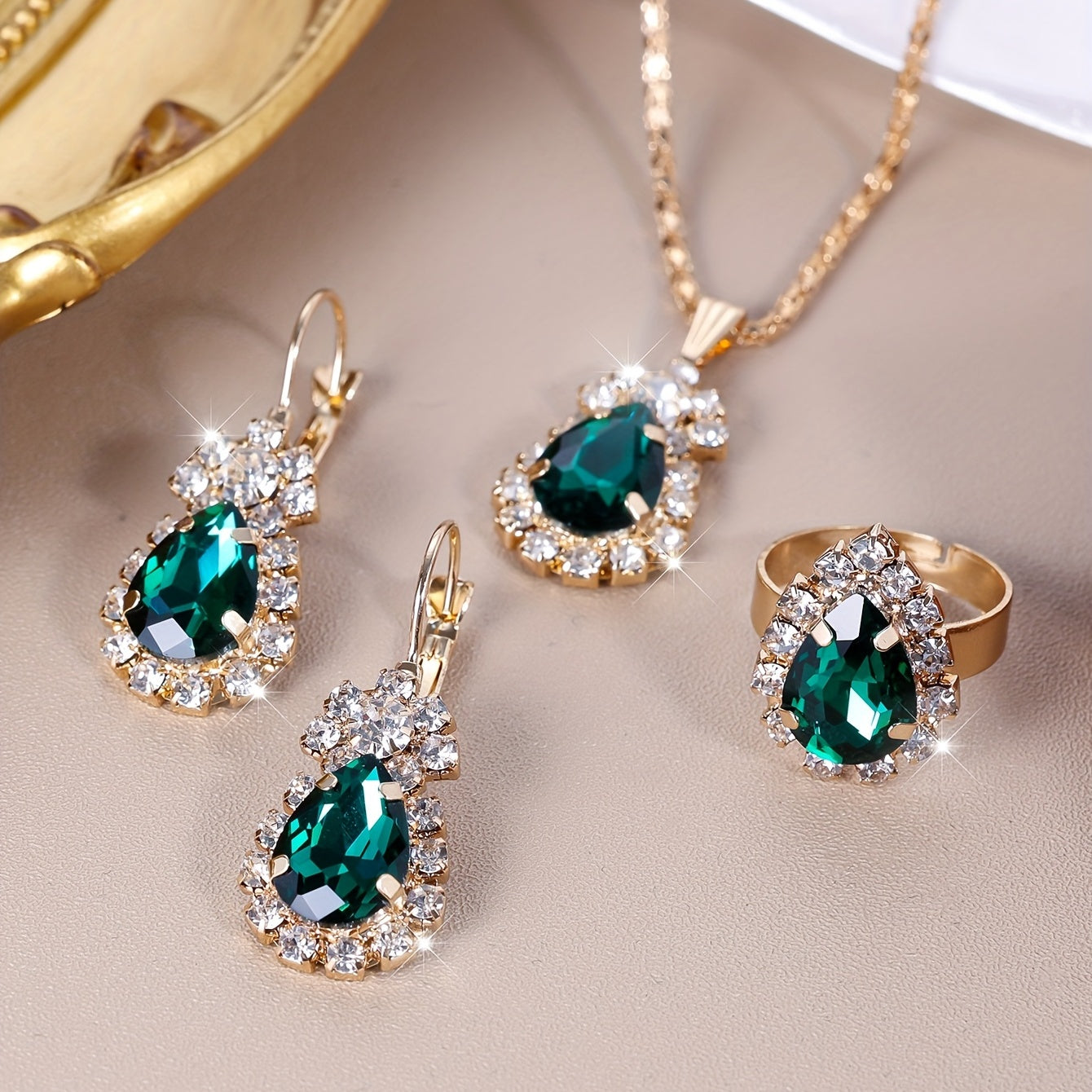 Complete your look with this elegant jewelry set featuring 4 pieces - earrings, necklace, and ring. Made with 18k gold plating and inlaid with shimmering zirconia in multiple colors to suit your style. Perfect for daily wear or adding a touch of glamour