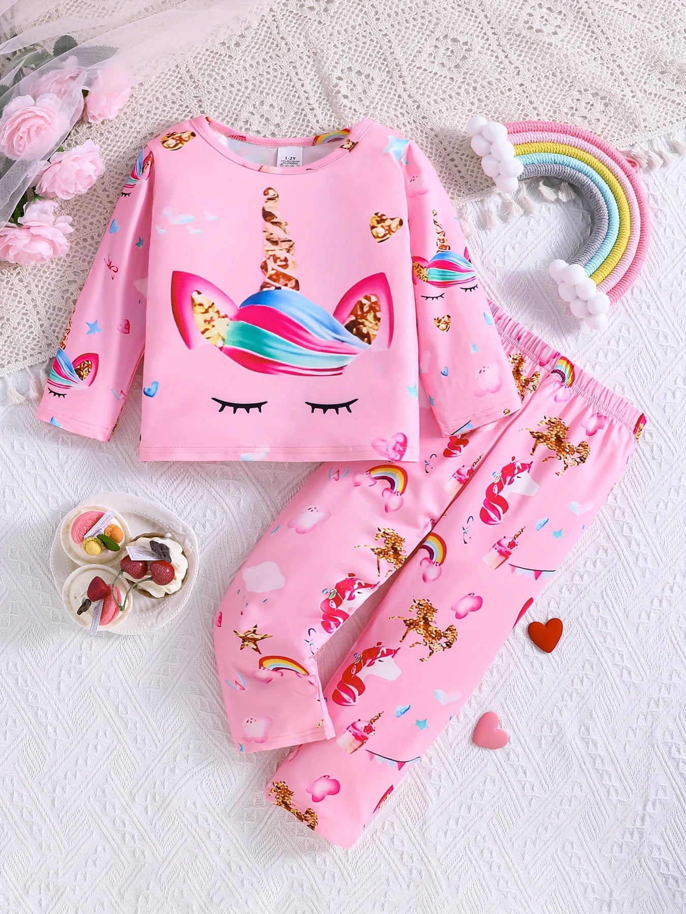 3-pack girls' flame resistant pajama sets with long sleeve crew neck featuring cartoon patterns. Designs include princess, unicorn, and donut cat. Made of polyester spandex for comfortable