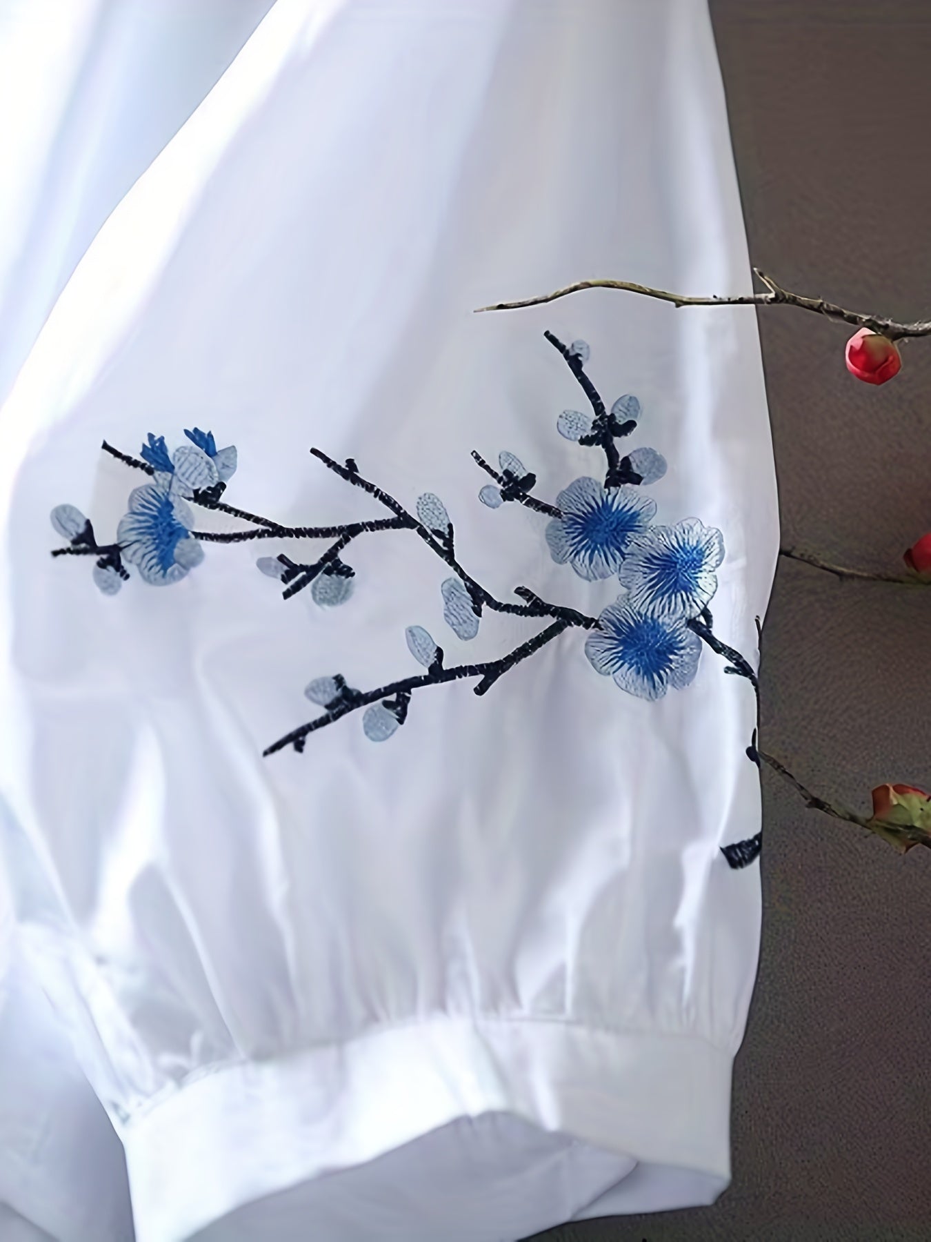 Embroidered blouse with elegant buttons and collar.