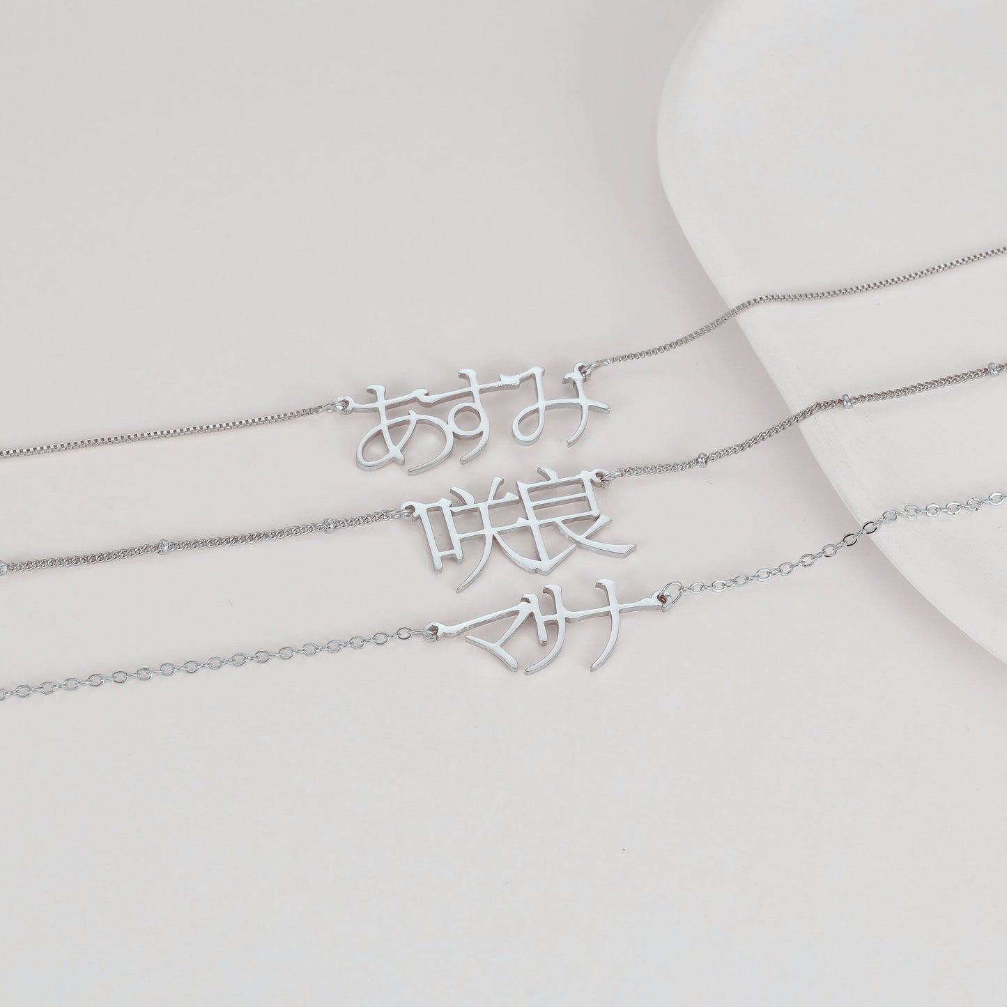 A unique Japanese Kanji name necklace made of stainless steel, featuring custom Katakana and Hiragana pendant. The perfect gift for your mom, sister, or best friend.