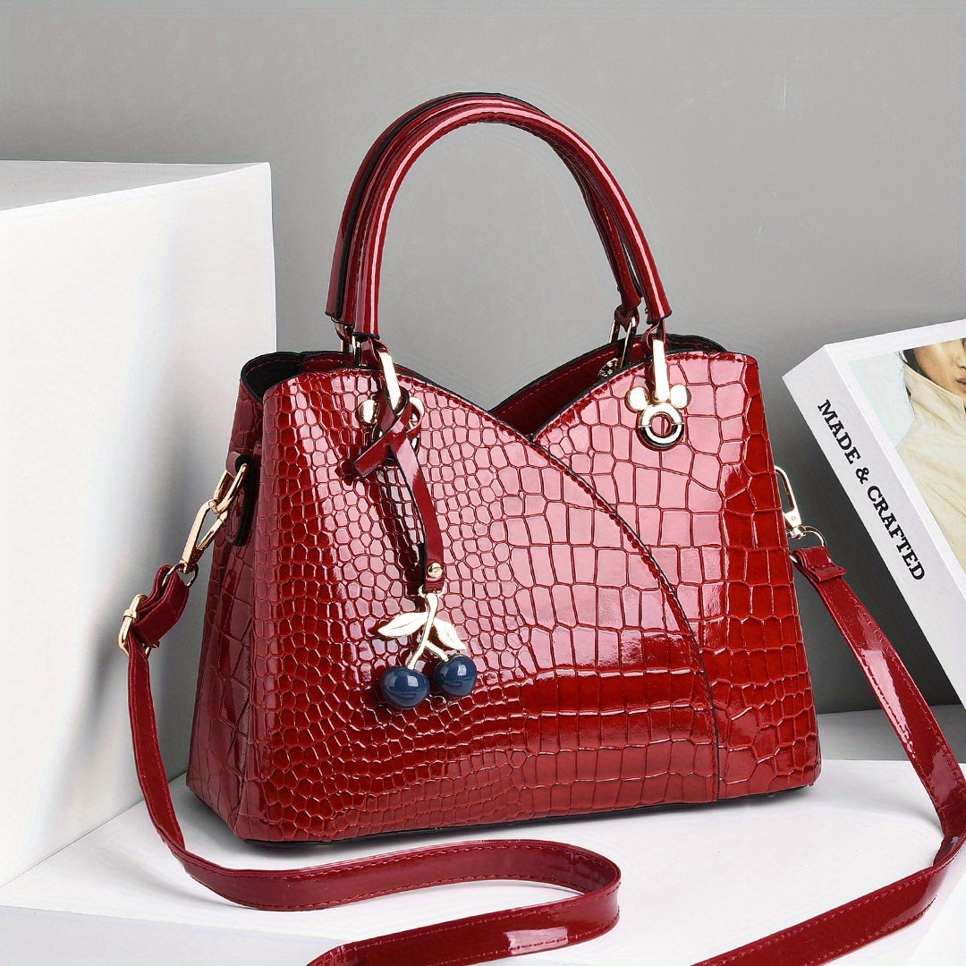 Stylish crocodile embossed tote bag with cherry pendant.