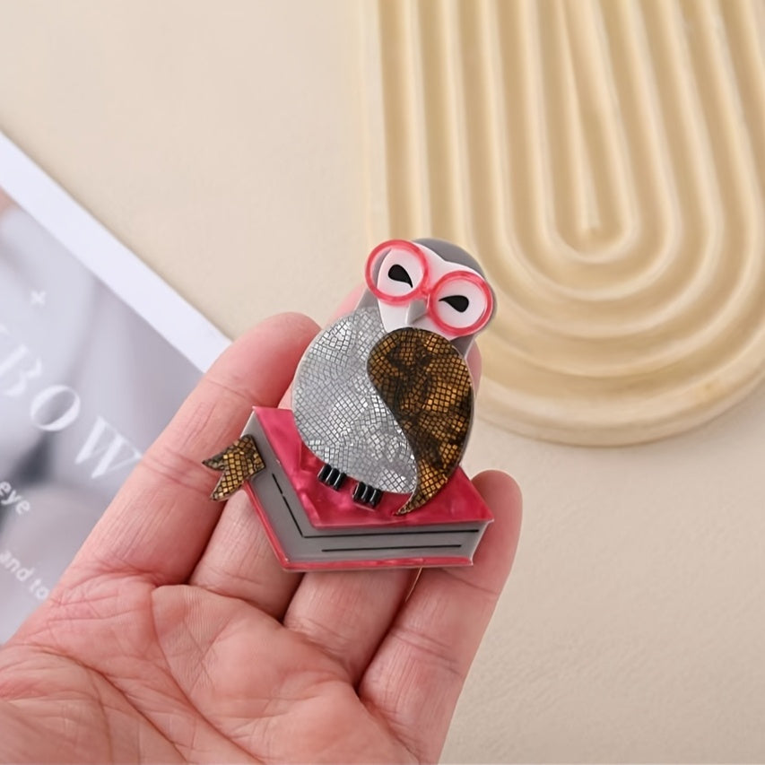 Novel and fashionable, this cute acrylic brooch features a cute bird standing on a book and wearing glasses. It is designed with an anti-see-through cartoon chest flower and retro pin for added decoration. Suitable for both men and women, this versatile