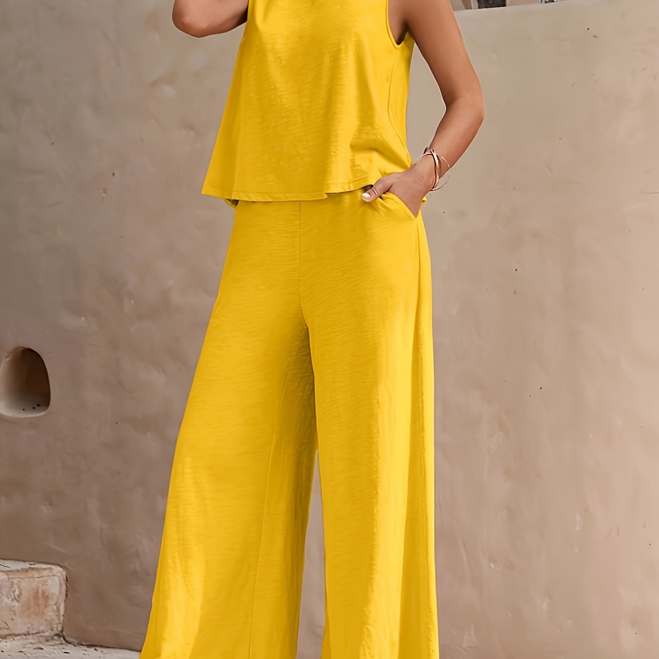 Elegant two-piece set with sleeveless tank top and wide leg loose pants for women.