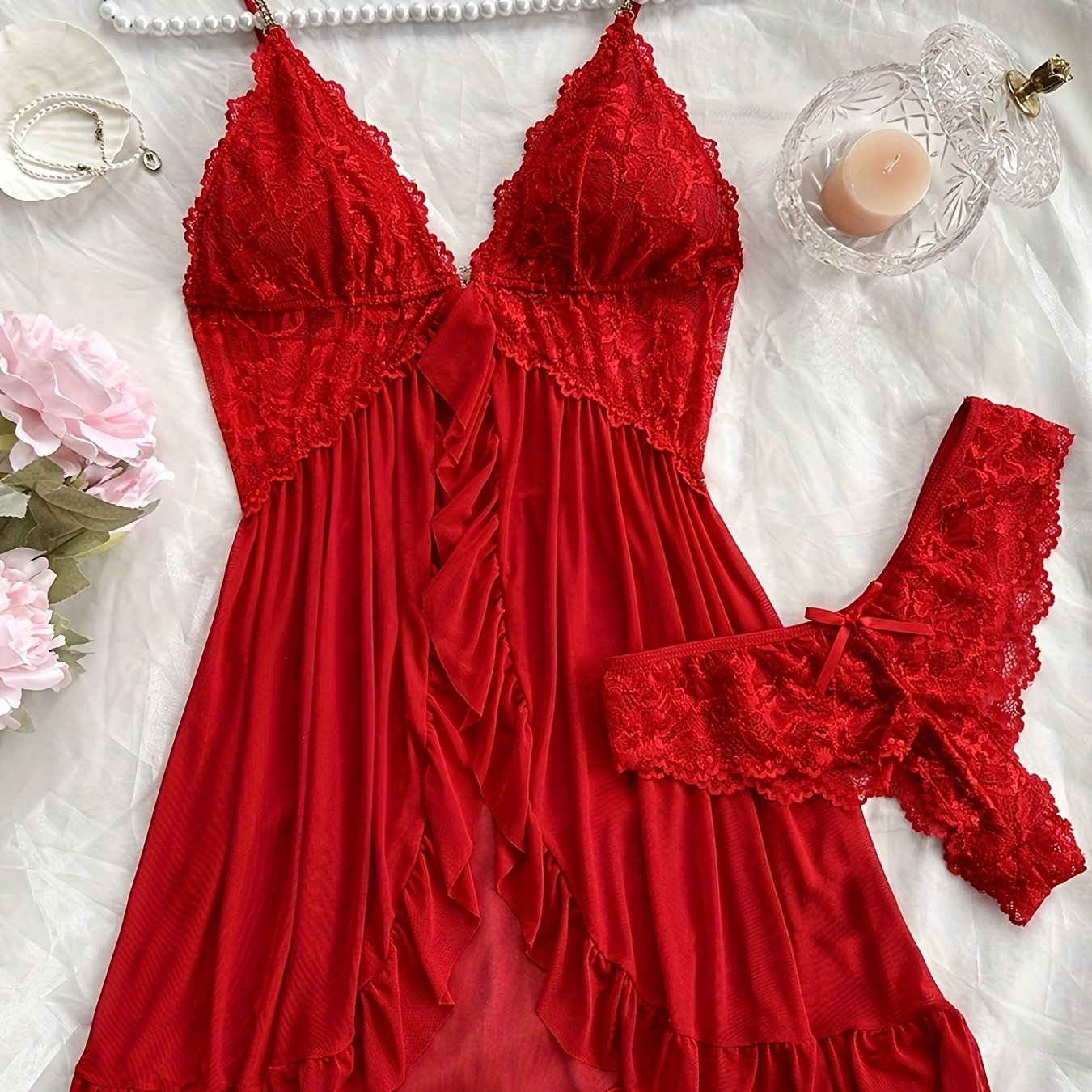 Stylish lace slip dress pajama set with V-neck, backless design, ruffle hem, and shorts. Made of breathable polyester blend, suitable for all seasons.