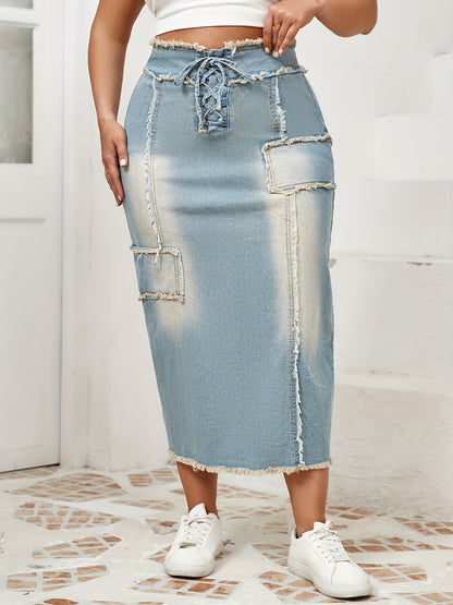 Women's high-waist denim midi skirt with frayed hem and lace-up details in a gradient light blue to dark wash. Raw edge detailing, versatile for spring/summer/fall.