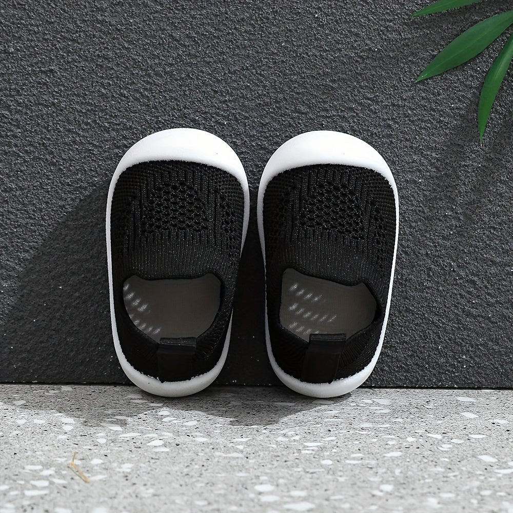 Soft infant walking shoes for toddlers made with knitted fabric.