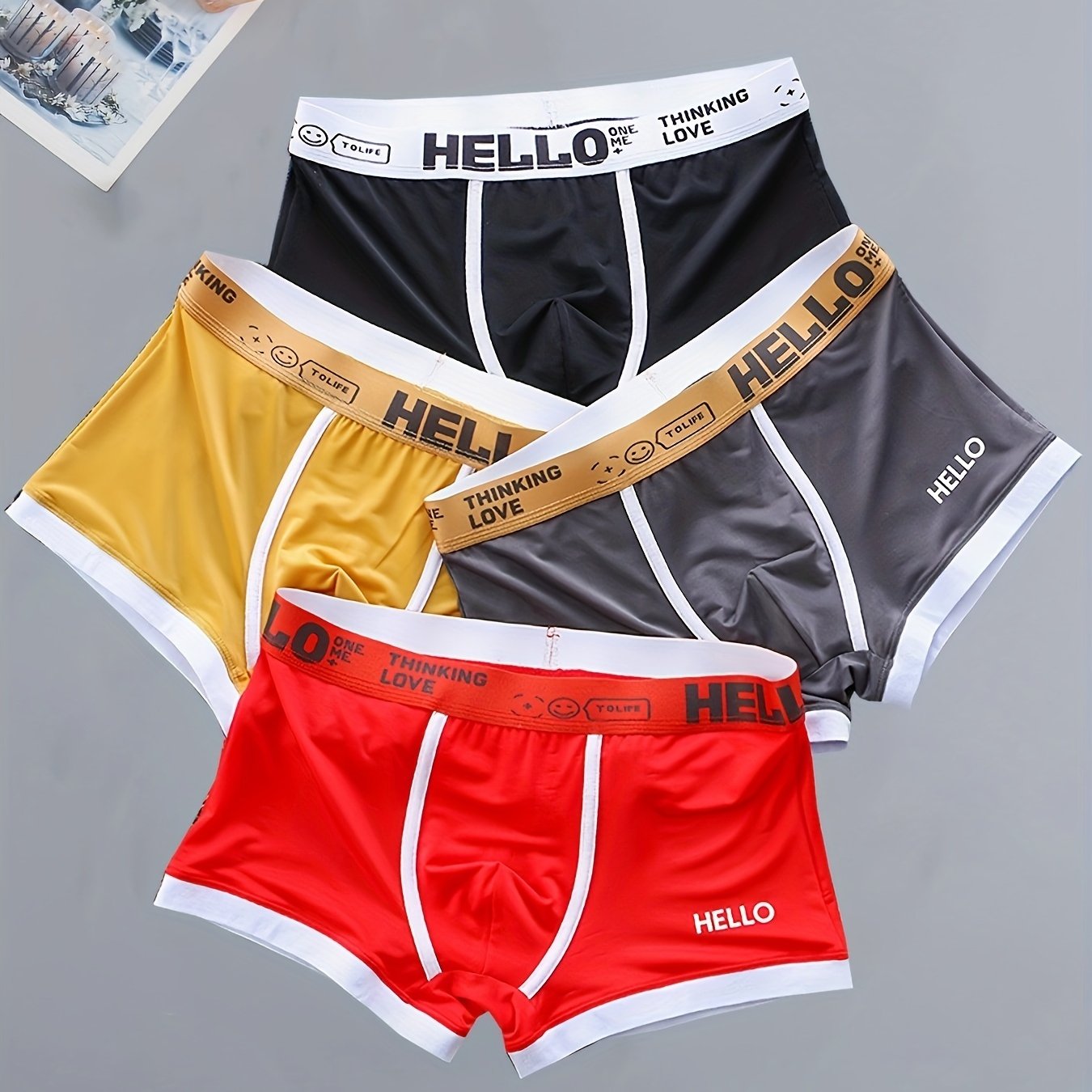 4 men's boxer briefs made with soft, breathable polyamide and elastane fabric featuring an alphabet pattern.